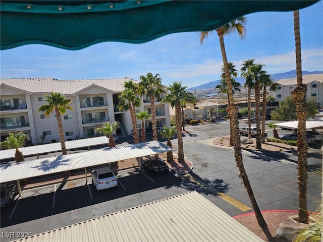 exterior space with a residential view, a mountain view, and curbs