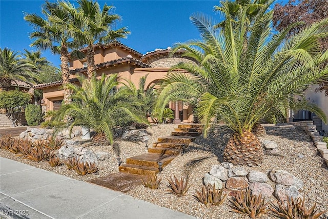 exterior space with a tile roof and stucco siding