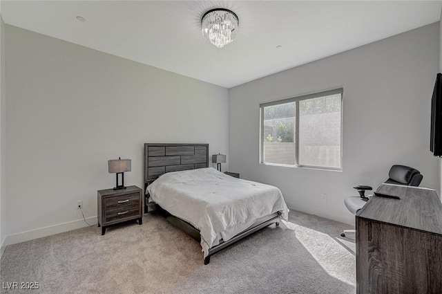 bedroom with baseboards, a chandelier, and light colored carpet