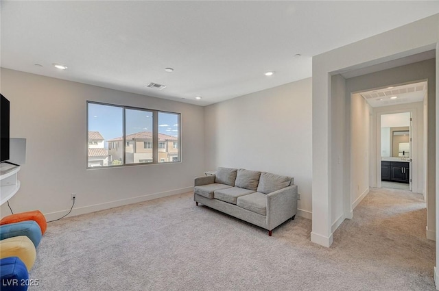 living area with light carpet, baseboards, visible vents, and recessed lighting