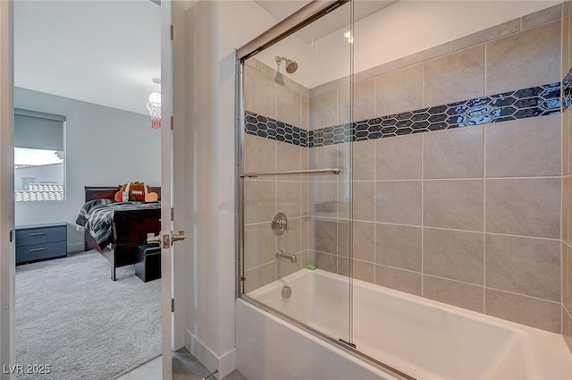 ensuite bathroom with combined bath / shower with glass door and connected bathroom