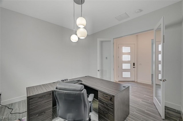 office featuring light wood-style flooring and baseboards