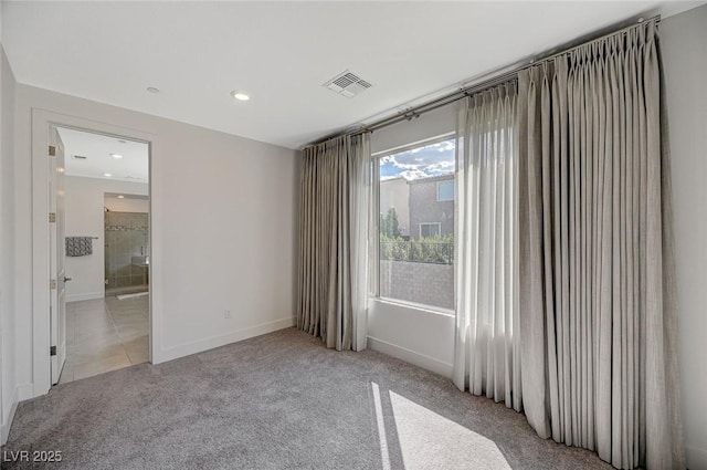 empty room with light carpet, recessed lighting, visible vents, and baseboards