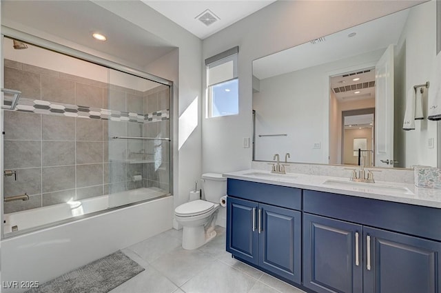 full bath with toilet, shower / bath combination with glass door, visible vents, and a sink