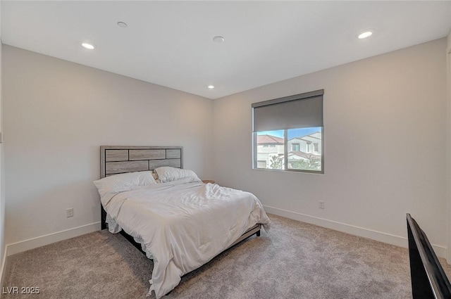 carpeted bedroom featuring baseboards and recessed lighting