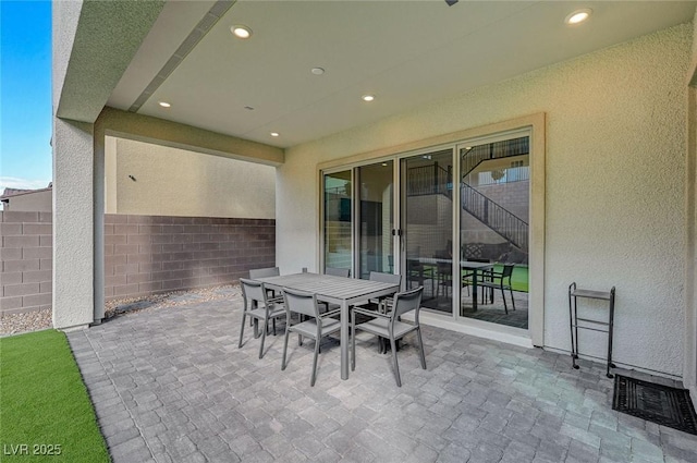 view of patio with visible vents, fence, and outdoor dining area