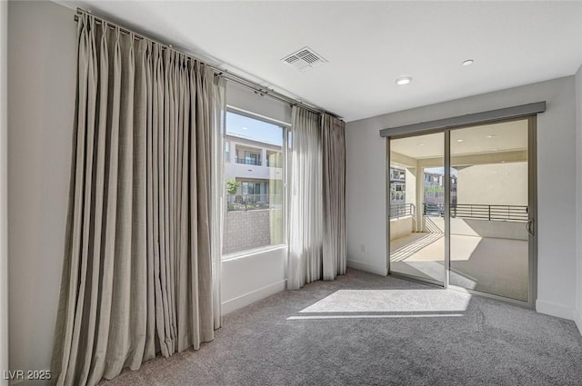 interior space featuring carpet floors, visible vents, and baseboards