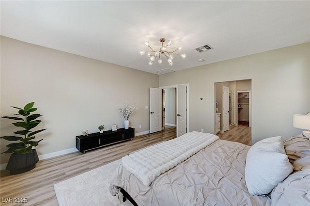 bedroom with baseboards, light wood finished floors, visible vents, and an inviting chandelier