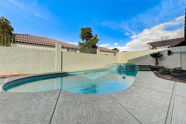 view of swimming pool featuring a patio area, a fenced backyard, and a pool with connected hot tub