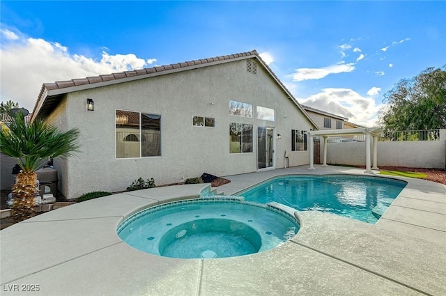 view of pool featuring a patio, fence, and a pool with connected hot tub