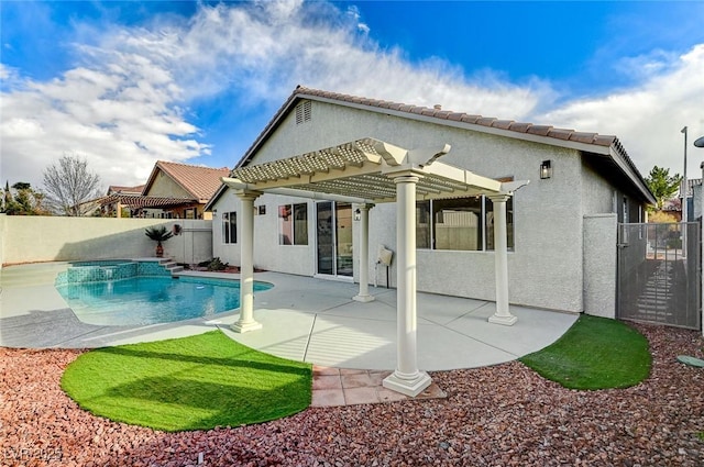 rear view of house with a patio area, stucco siding, a fenced backyard, and a pergola