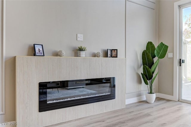 interior details featuring wood finished floors and baseboards