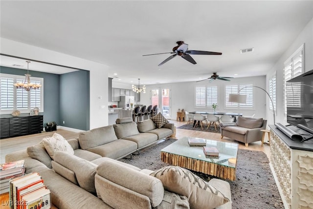 living area with recessed lighting, light wood-style floors, a notable chandelier, and visible vents