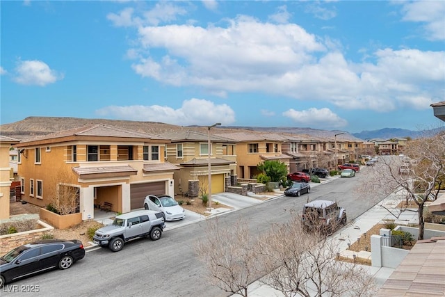 view of street with a mountain view, curbs, and a residential view