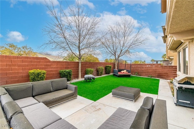 view of patio featuring area for grilling, an outdoor living space, and a fenced backyard