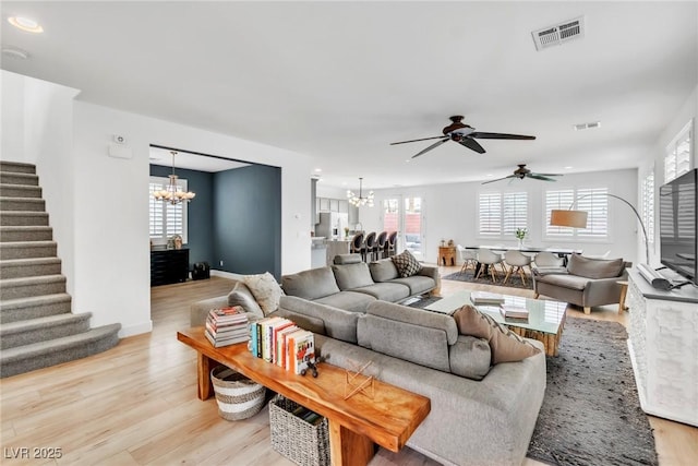 living room featuring stairway, plenty of natural light, light wood-style flooring, and visible vents