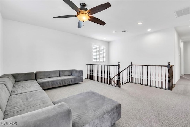 carpeted living room featuring recessed lighting, visible vents, and a ceiling fan