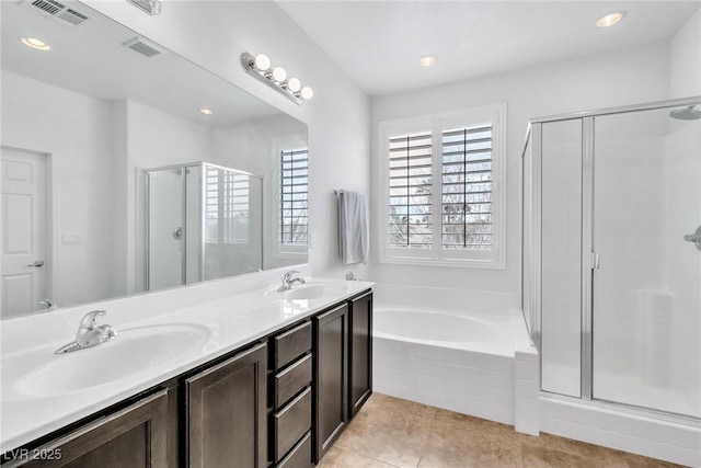 full bathroom with a sink, visible vents, a bath, and a shower stall