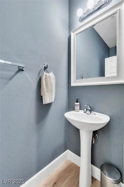 bathroom featuring wood finished floors and baseboards