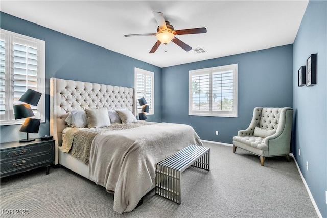 bedroom featuring visible vents, baseboards, carpet floors, and a ceiling fan