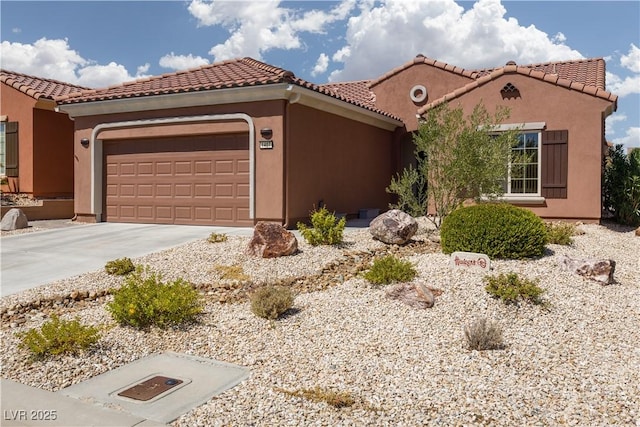 mediterranean / spanish-style house featuring a garage, driveway, and stucco siding