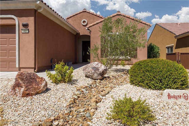 view of front of property featuring a tile roof and stucco siding