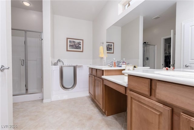 bathroom featuring visible vents, a shower stall, vanity, and tile patterned floors