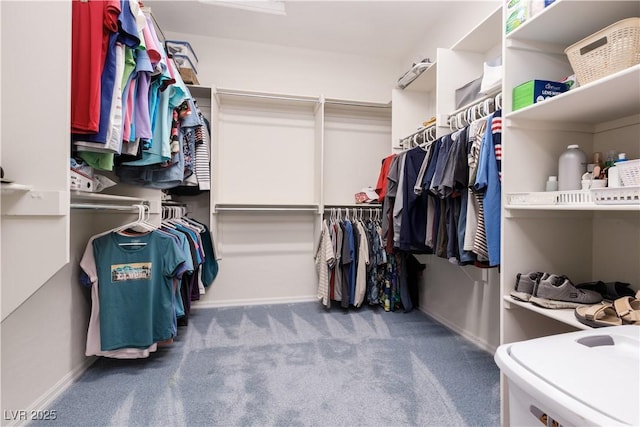 walk in closet with carpet