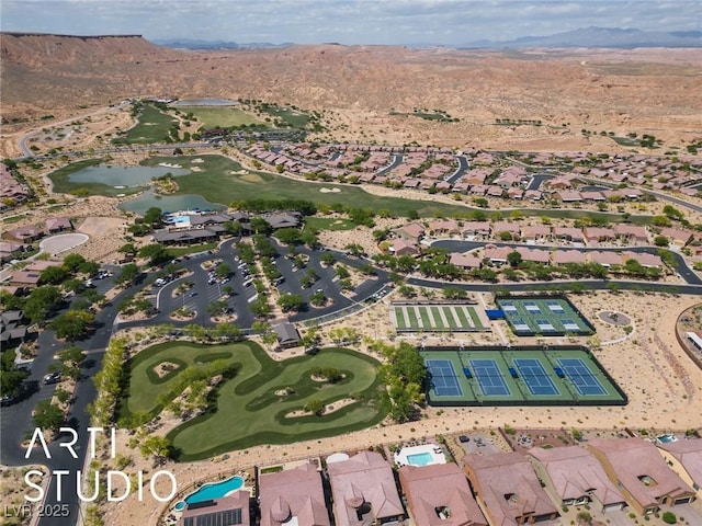 drone / aerial view with a residential view, view of golf course, and a mountain view