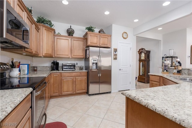 kitchen with light stone counters, light tile patterned flooring, a toaster, recessed lighting, and appliances with stainless steel finishes