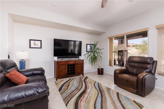 living area with light tile patterned flooring and baseboards