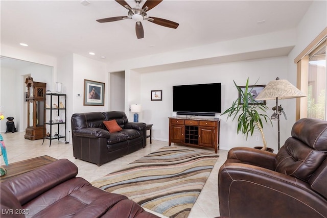 living room featuring a ceiling fan, recessed lighting, baseboards, and light tile patterned floors