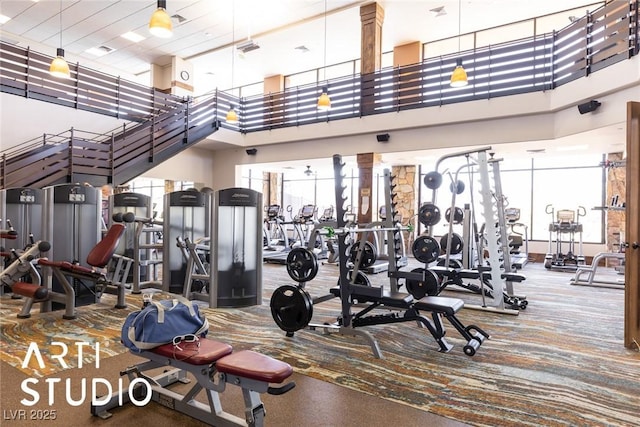 workout area featuring a high ceiling and visible vents