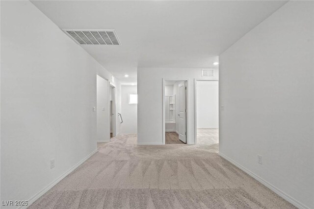 empty room featuring baseboards, visible vents, and carpet flooring