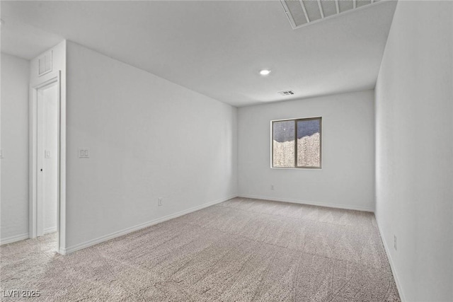 carpeted spare room featuring visible vents and baseboards