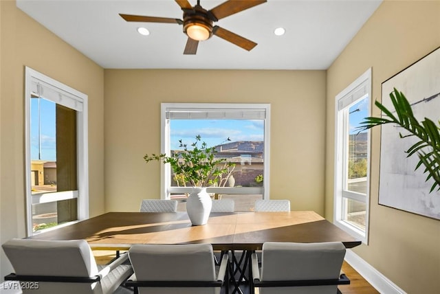 dining room with wood finished floors, recessed lighting, and baseboards