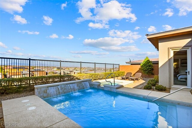 view of swimming pool featuring a patio, a pool with connected hot tub, and fence