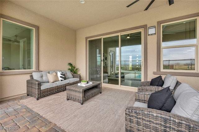 view of patio with an outdoor living space and a ceiling fan