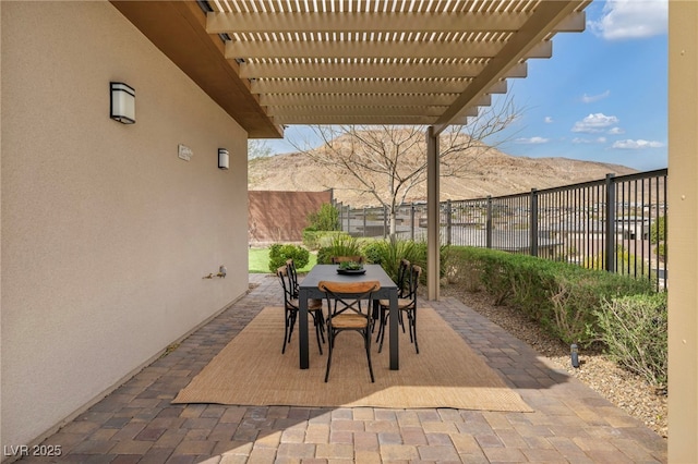 view of patio / terrace with outdoor dining space, fence, and a pergola