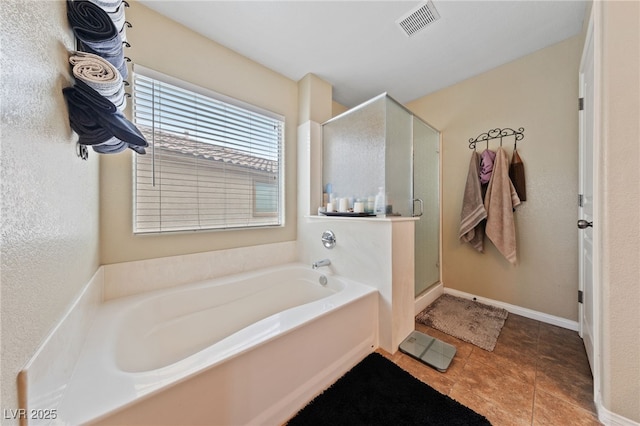 bathroom with a stall shower, visible vents, baseboards, tile patterned floors, and a garden tub