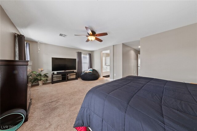 bedroom featuring a ceiling fan, visible vents, carpet flooring, and ensuite bathroom