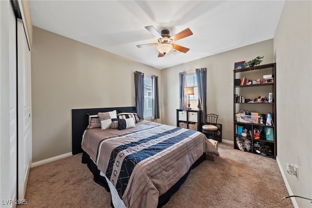 carpeted bedroom with baseboards and a ceiling fan