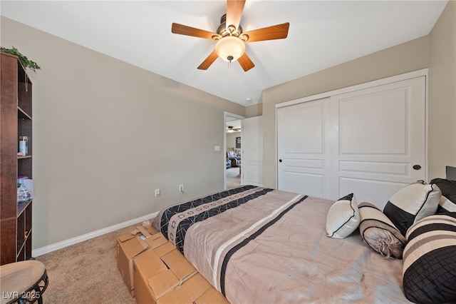 bedroom featuring carpet floors, a closet, baseboards, and a ceiling fan