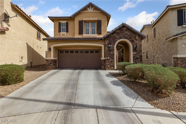 view of front of house featuring a garage, a tile roof, concrete driveway, stone siding, and stucco siding