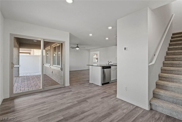 interior space featuring recessed lighting, stairway, light wood-style flooring, ceiling fan, and a sink