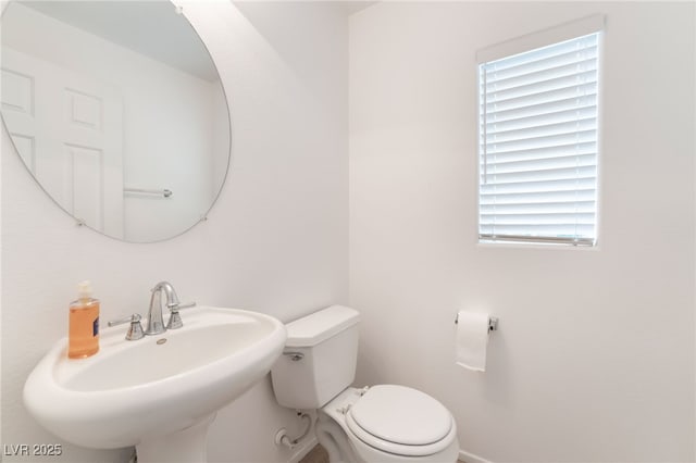 half bathroom with a sink and toilet