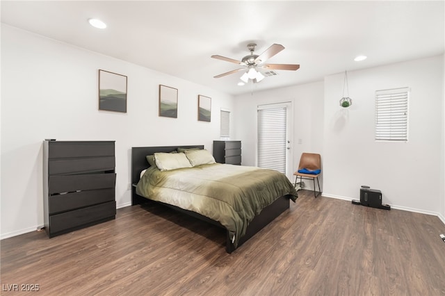 bedroom with recessed lighting, wood finished floors, and baseboards