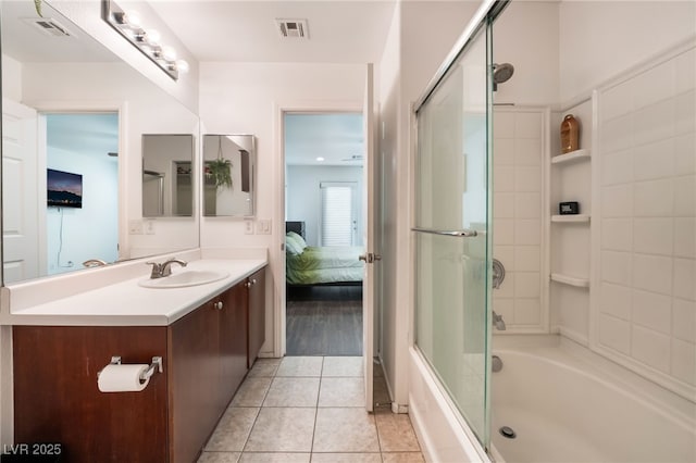 full bathroom featuring ensuite bathroom, bath / shower combo with glass door, vanity, and visible vents