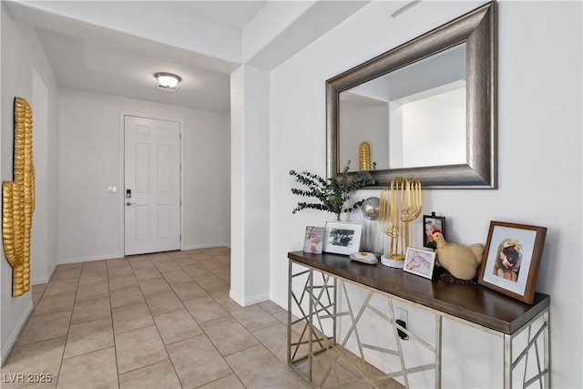 entrance foyer with baseboards and light tile patterned flooring