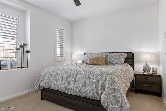 bedroom with a ceiling fan, carpet flooring, and baseboards